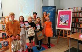 Dwie kobiety i grupa dzieci pozuje do wspólnej fotografii.