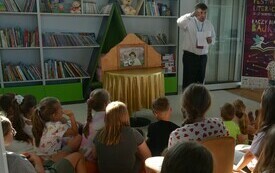 Ksiądz występujący z teatrzykiem dla dzieci.