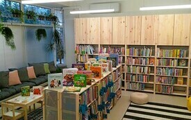 Widok wnętrza biblioteki z p&oacute;łkami pełnymi książek