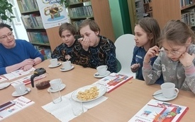 Dzieci siedzą i rozmawiają. na stole książki z DKK, o których jest spotkanie.