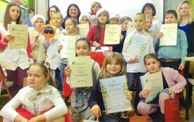 Grupa nagrodzonych w konkursie dzieci, wszyscy trzymają w ręku dyplomy. 