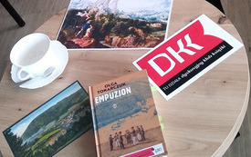 Stolik, logo Dyskusyjnych Klubów Książki, książka "Empuzjon" Olgi Tokarczuk