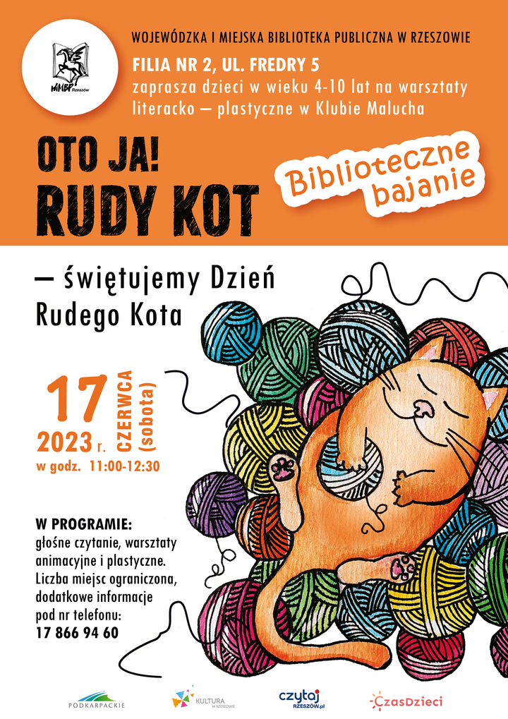 Rudy kot śpiący na stosie kłębków wełny. 