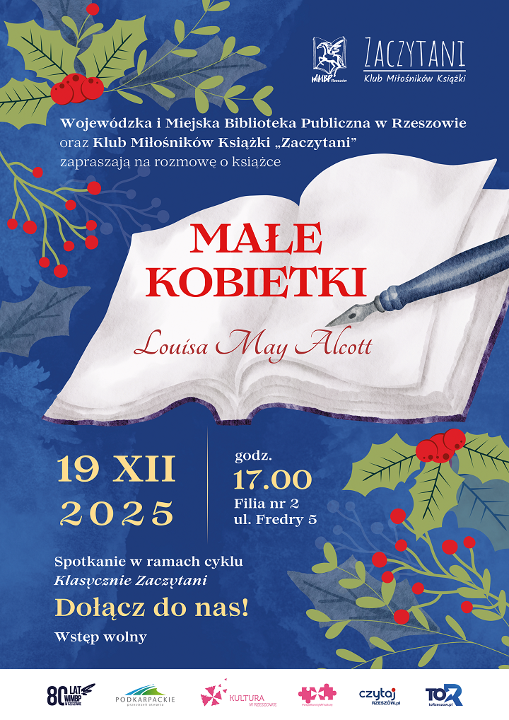 Książka z piórem i świąteczne akcenty dekoracyjne. 